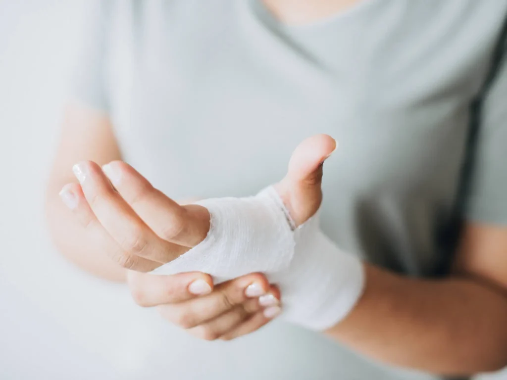 resize woman with gauze bandage wrapped around her hand